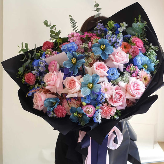 Pink and blue flowers bouquet by noble garden florist